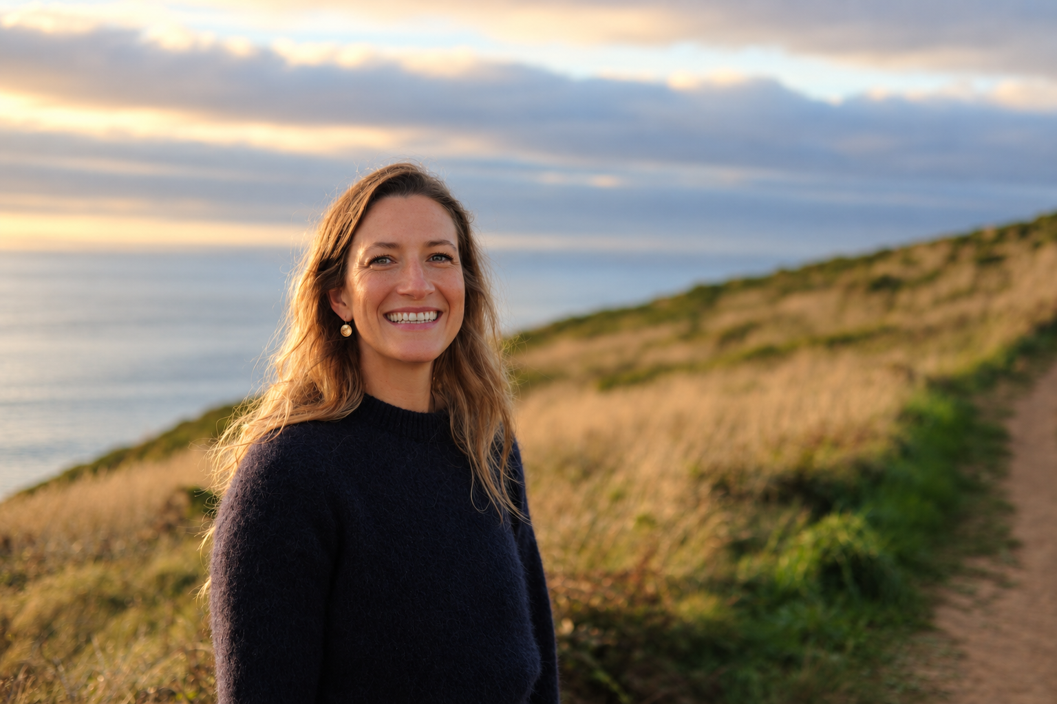 Bronwyn Lear smiling on the Cornish coast path